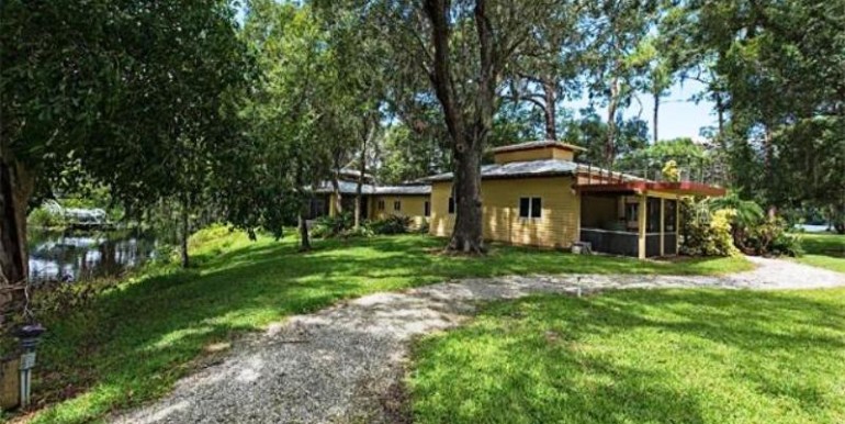 Home Rear View with Screened Lanai and Circular Stairs to Observ