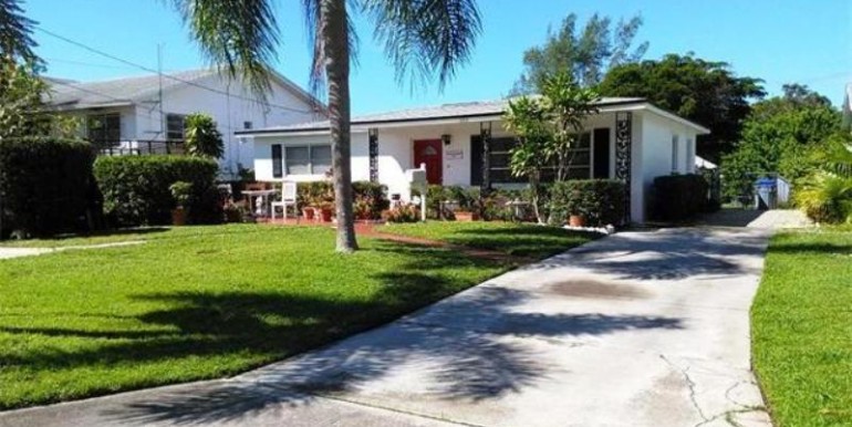 Driveway leads to gated waterfront rear yard.