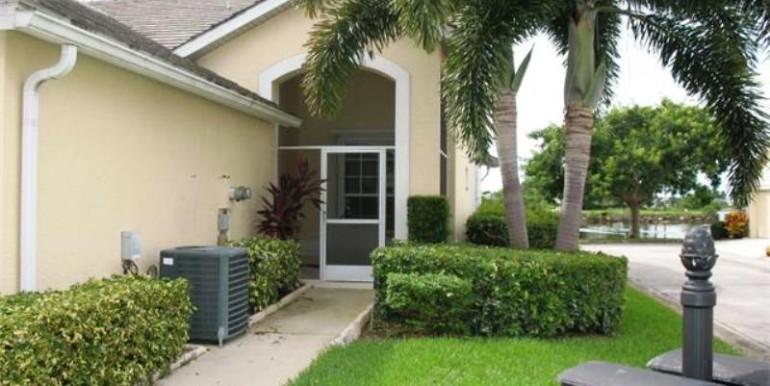 End unit, front entry is screened and features a planter inside.