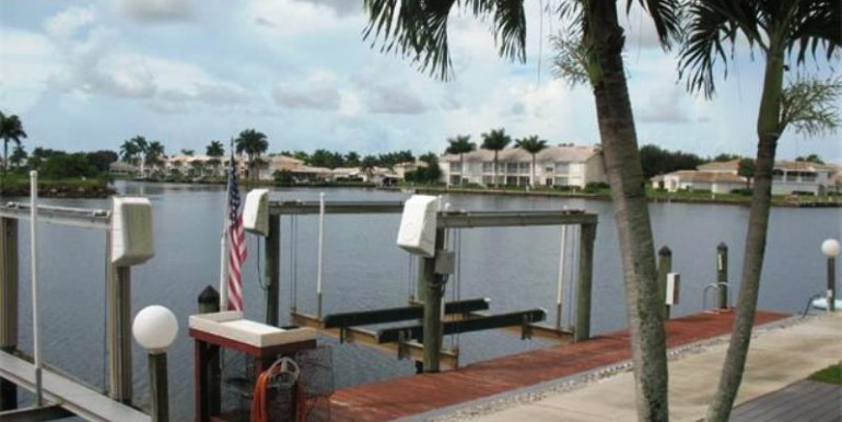 Boat lift in your back yard across wide canal with proximity to