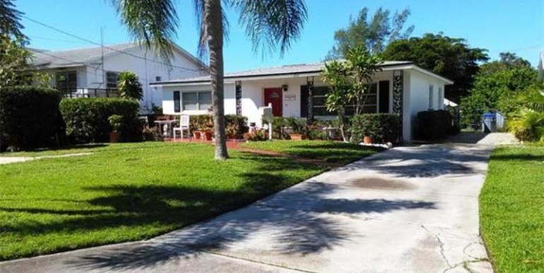 Driveway leads to gated waterfront rear yard.